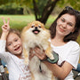 Mother and daughter hugging a dog