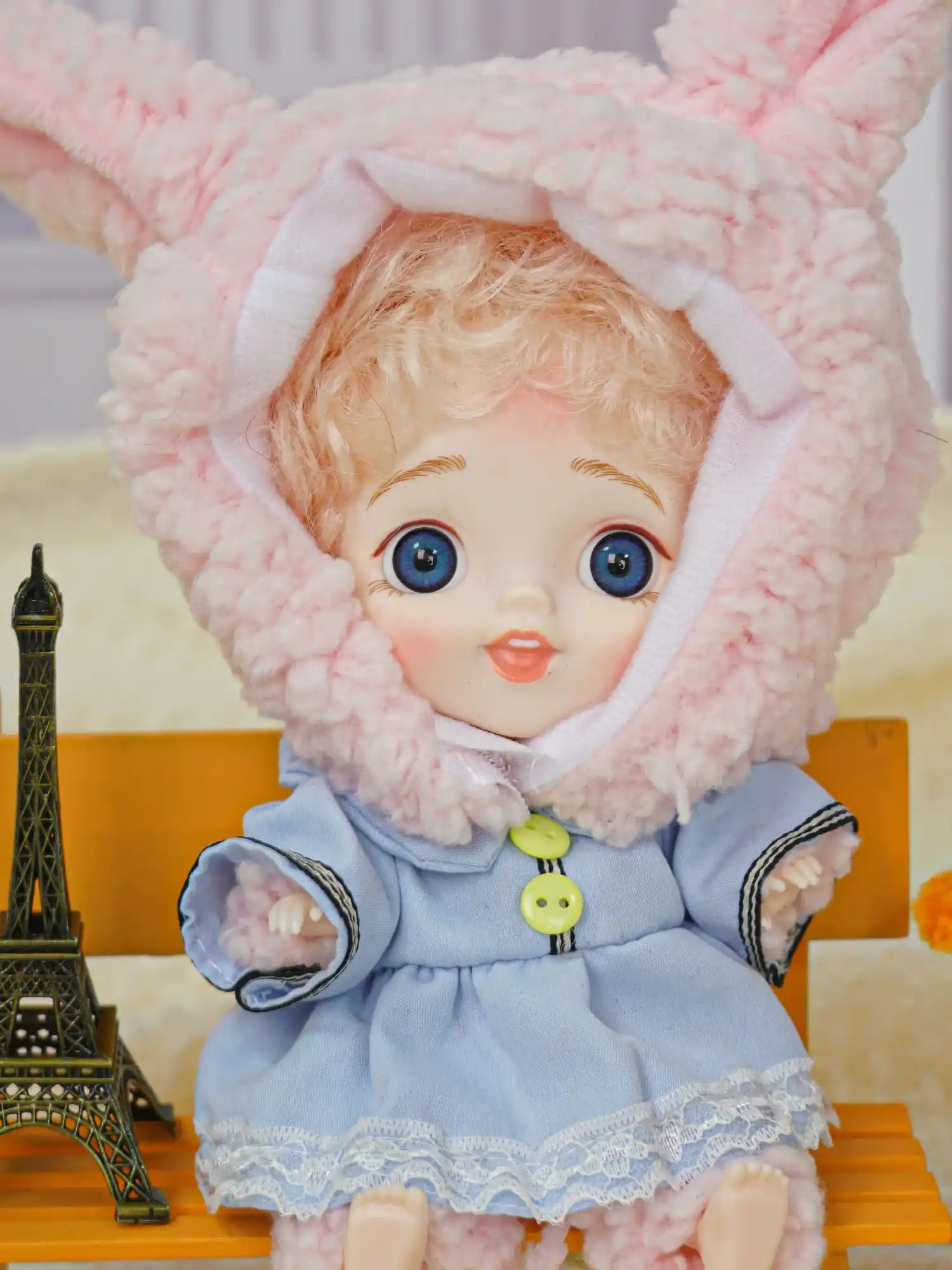 BJD clad in blue with bunny ears, blue eyes, and a tiny Eiffel Tower.