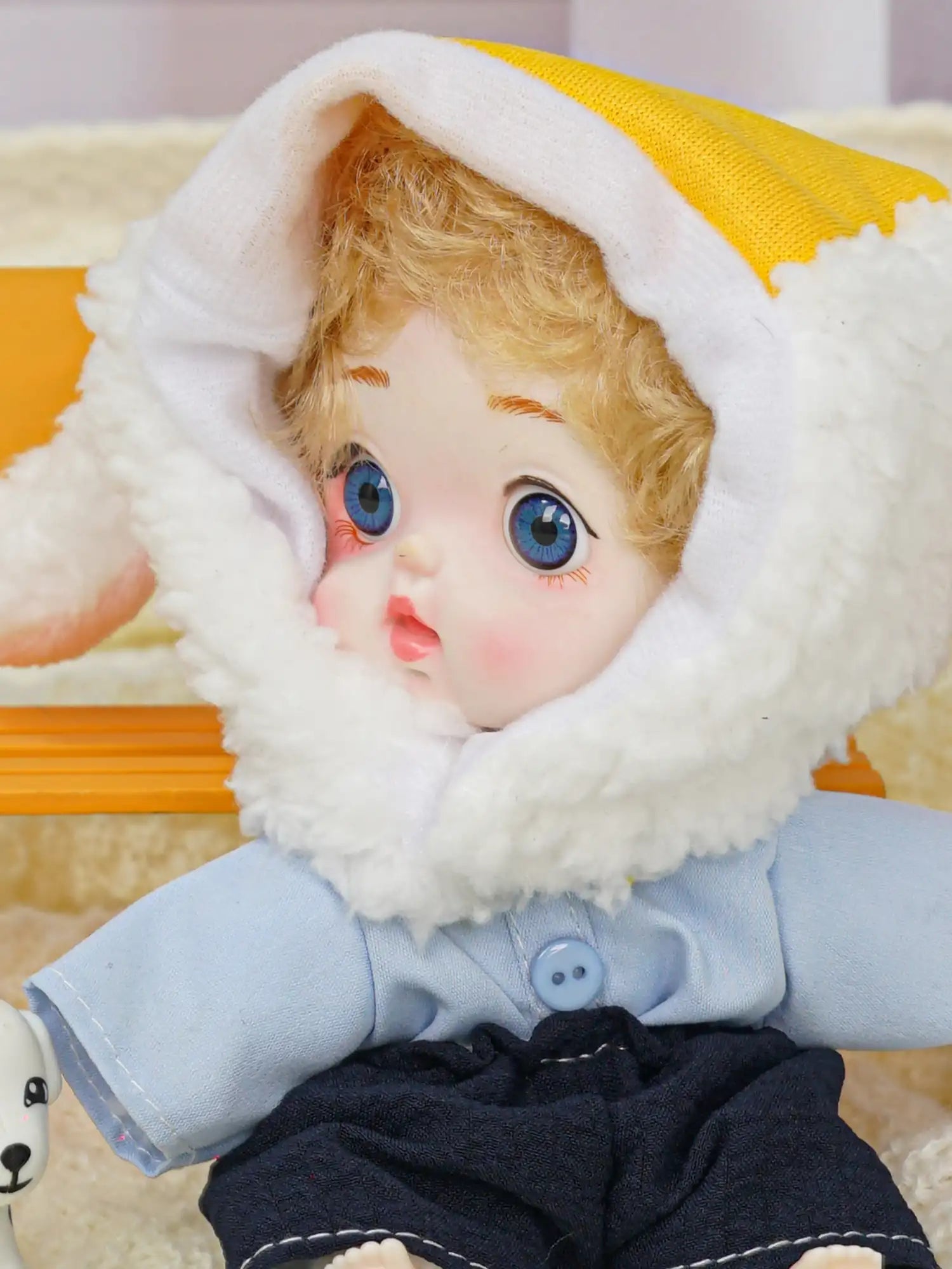 An adorable doll with a fluffy lamb headgear and a pair of bright eyes, sharing space with a little toy canine.