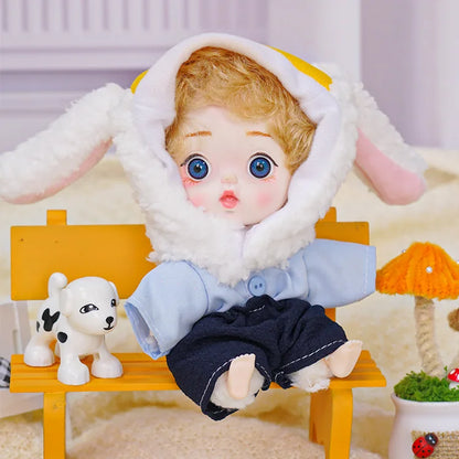 An endearing doll with a sheep-themed hat and a curious gaze, alongside a playful puppy toy and small decorations.