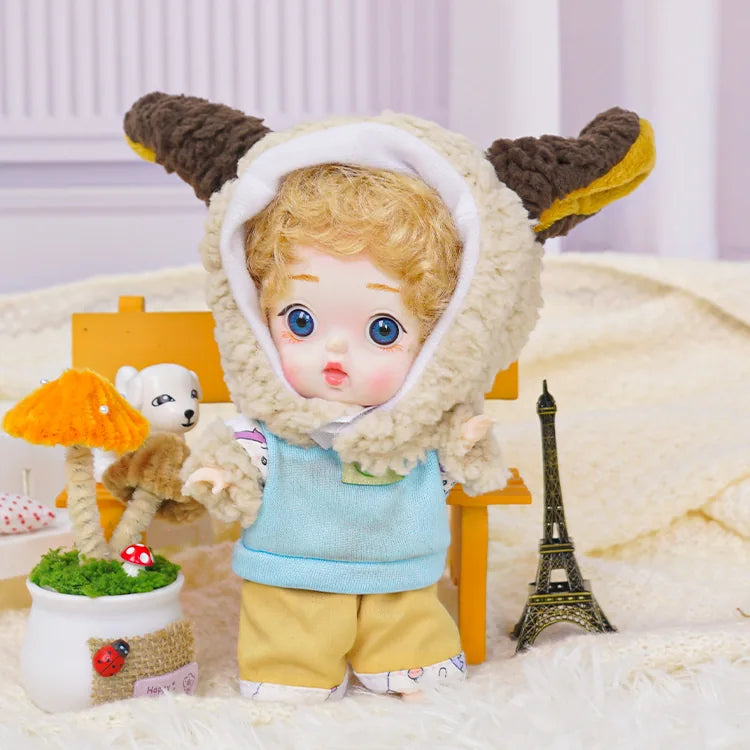 An expressive BJD dressed in a whimsical lamb hooded outfit, accompanied by playful miniature companions.