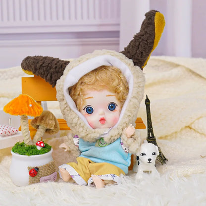 A ball-jointed doll with lamb ears and a loving gaze, nestled next to a small Eiffel Tower and a puppy figurine.