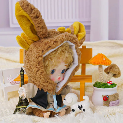 A fantasy scene with a doll in a bunny outfit, complete with a toy Eiffel Tower and a white puppy figurine.