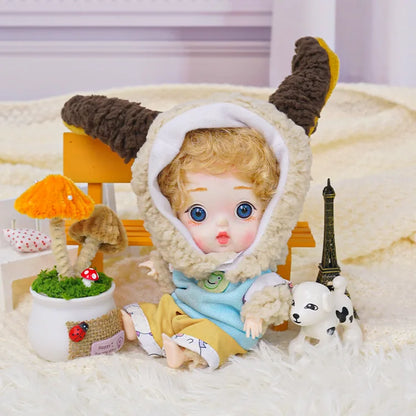 A BJD in a cute lamb outfit holds the attention with its vivid eyes, with a mini Eiffel Tower and toy dog as accents.