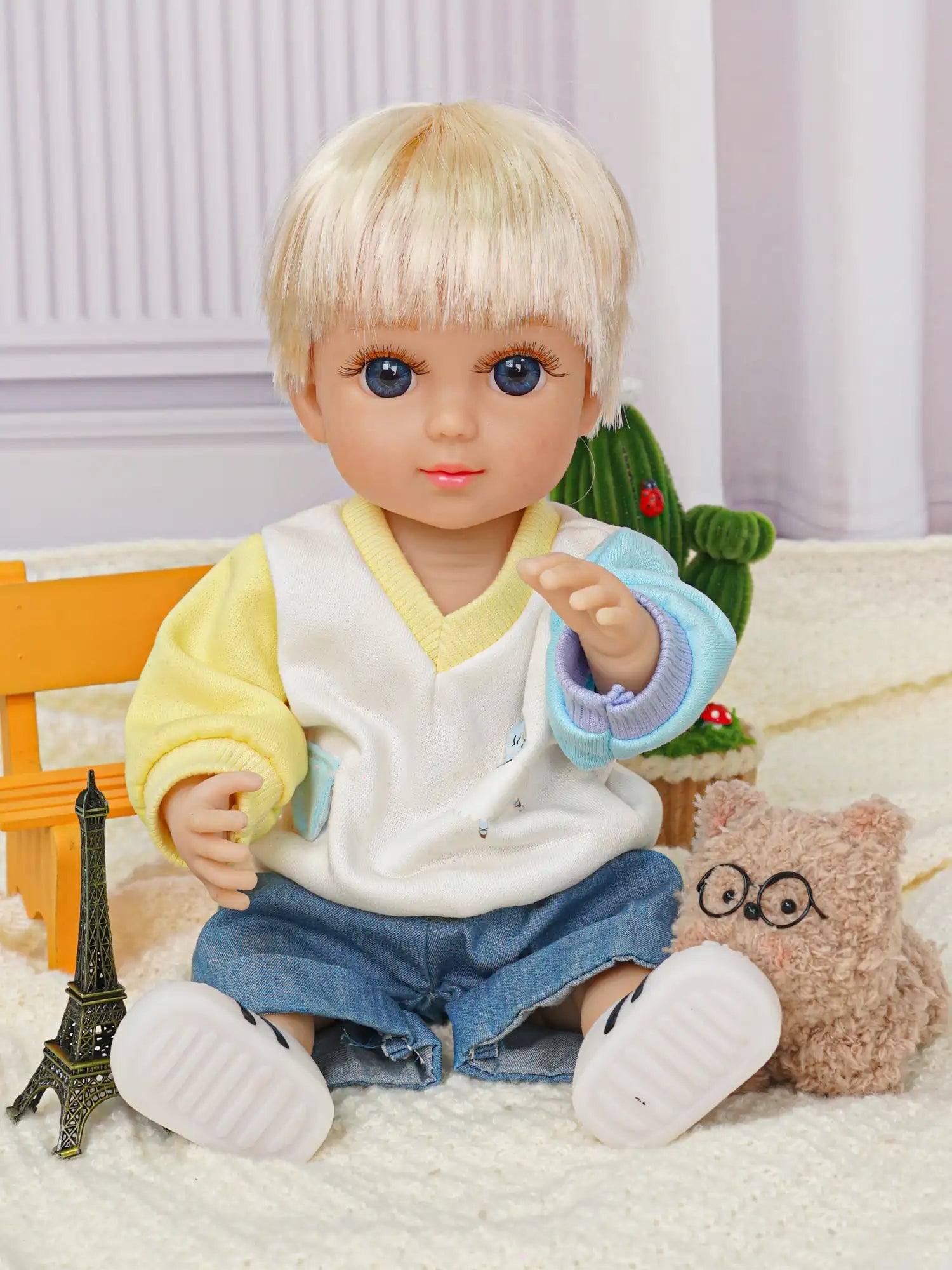 Fashion doll in a casual blue and yellow sweater, denim shorts, with a mini metal tower.