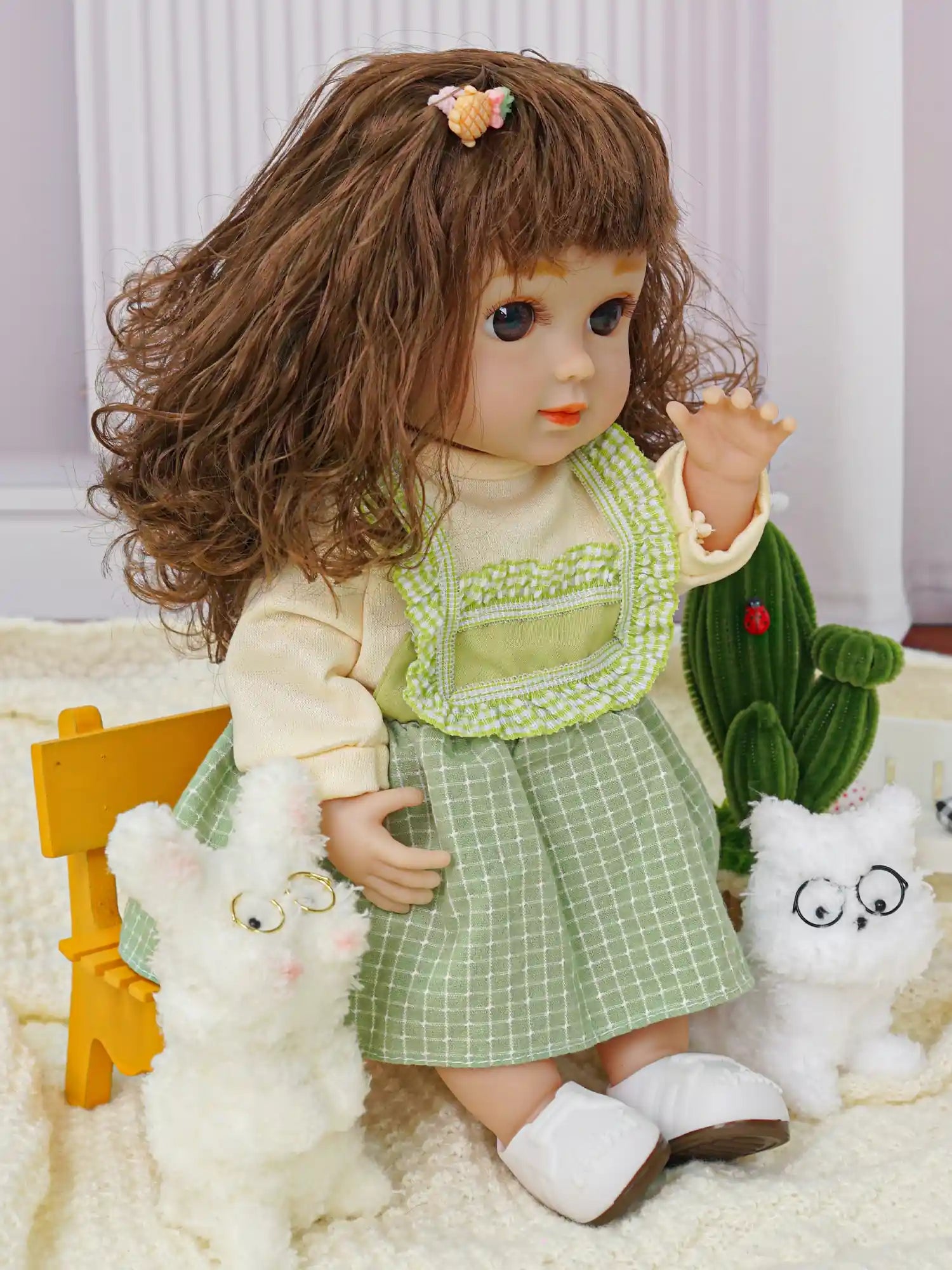 Childlike doll with a friendly expression, in a green jumper and white shoes, with toy dogs.