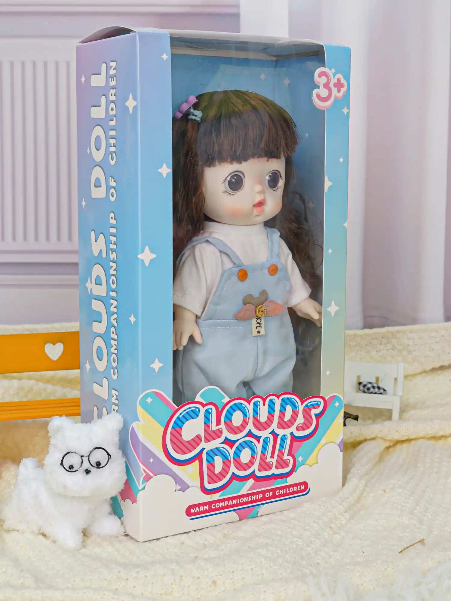 Playful doll with a purple hair clip, sporting a pastel blue jumpsuit with orange buttons, in a scene with Parisian flair.
