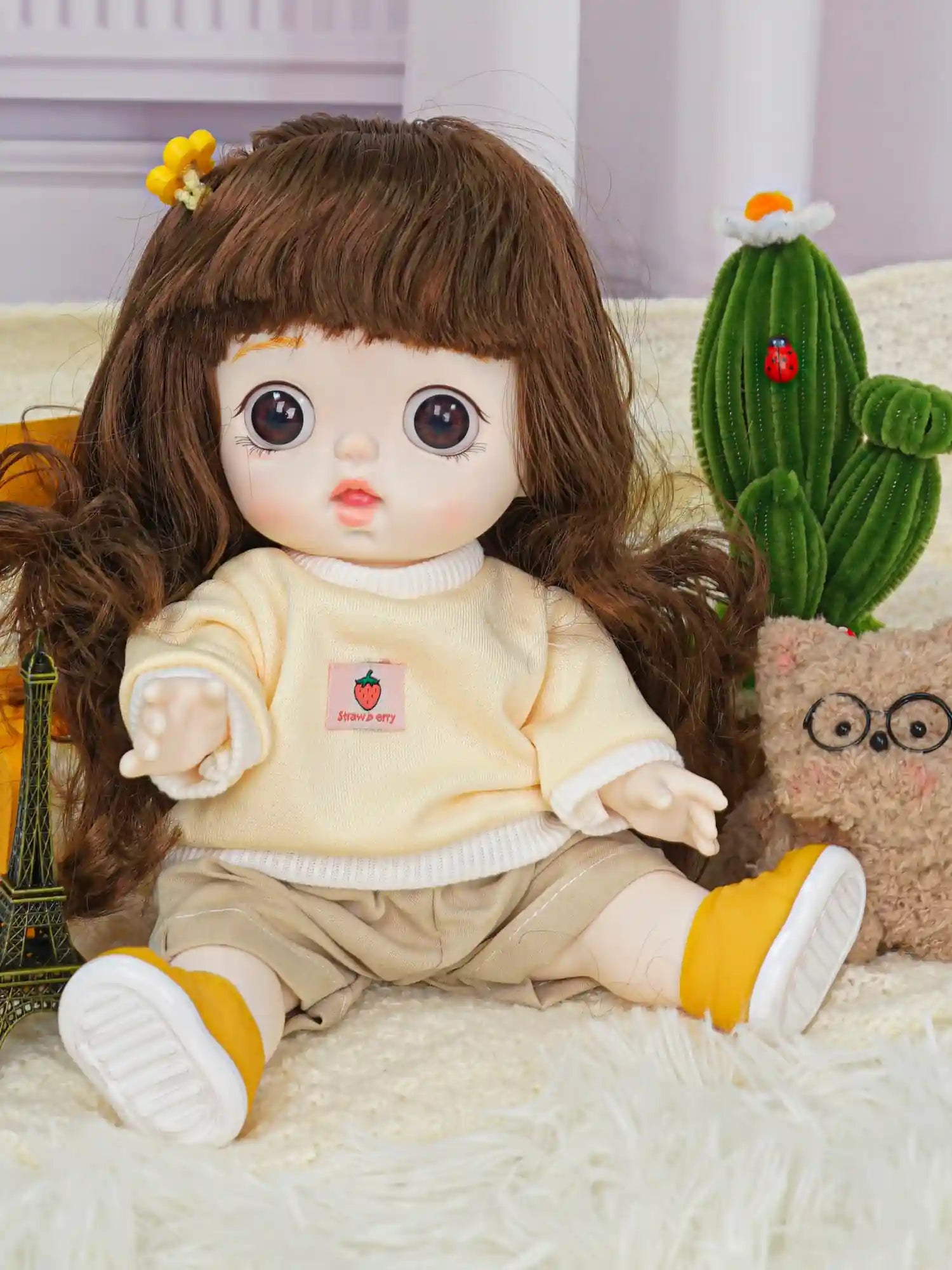 Adorable doll with brown eyes and a cute hairstyle, dressed in a cozy outfit, sharing a scene with a plush toy.
