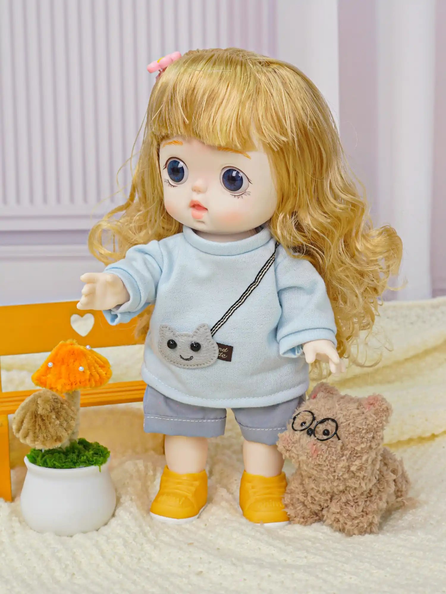 A golden-haired doll with a pink hair clip stands next to a plush animal and a miniature Eiffel Tower, evoking a Parisian theme.