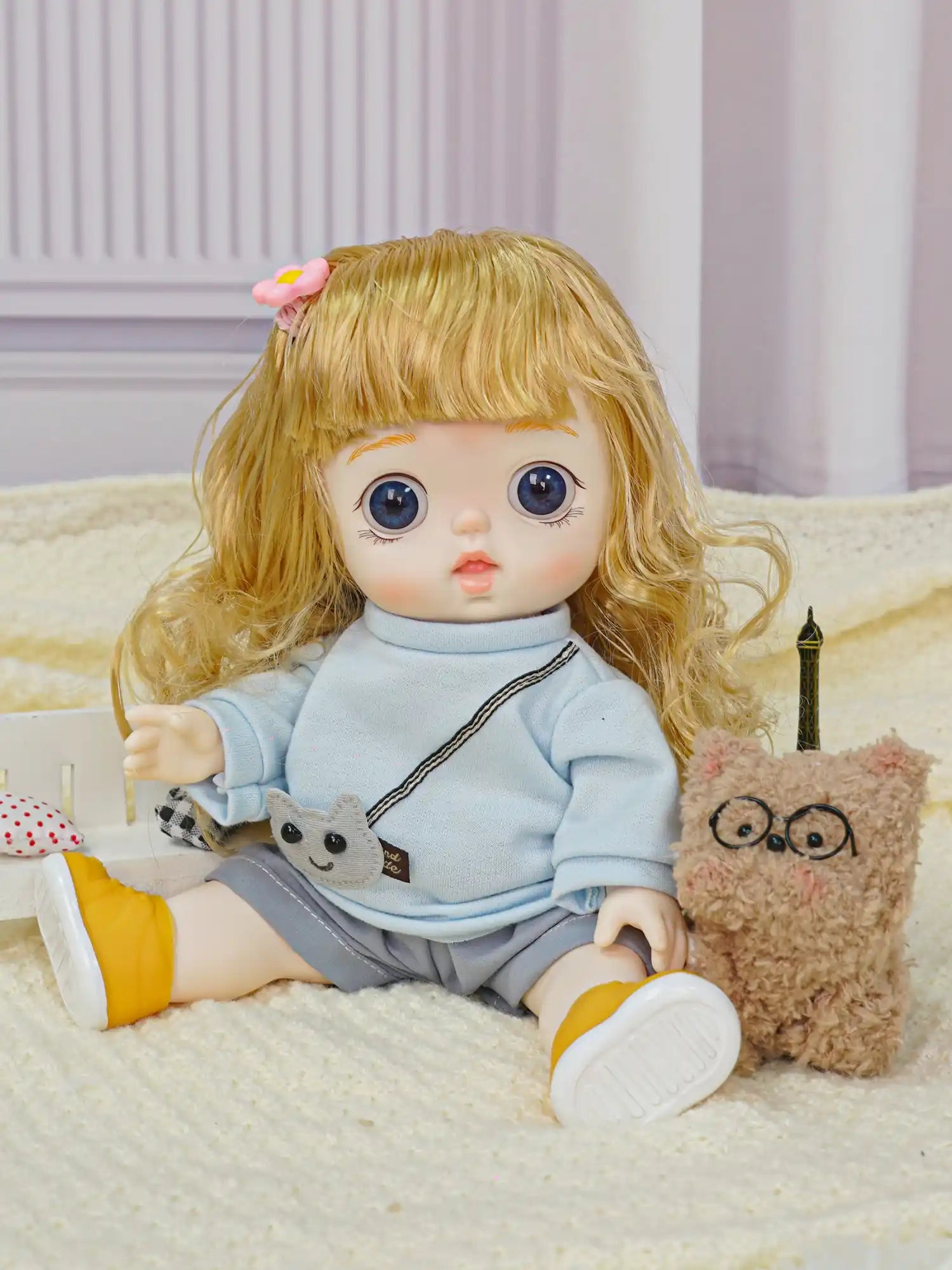 A playful doll with cheerful attire, including a crossbody animal bag, in a setup with a whimsical plush and toy décor.
