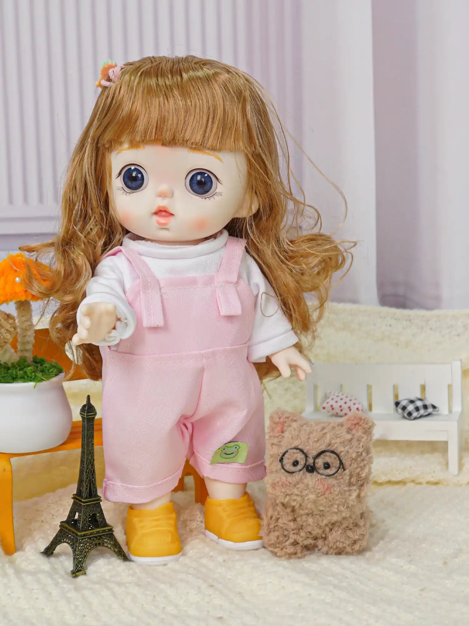 Toy doll with soft features and a cute hair accessory, in playtime attire with a plush companion and a miniature landmark.