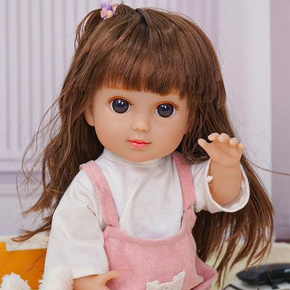 Doll with brown hair and pink overalls, waving, with a toy dog and Eiffel Tower.