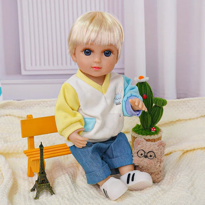 Childlike doll with short blonde hair, wearing a sporty outfit, next to a plush toy and cactus.