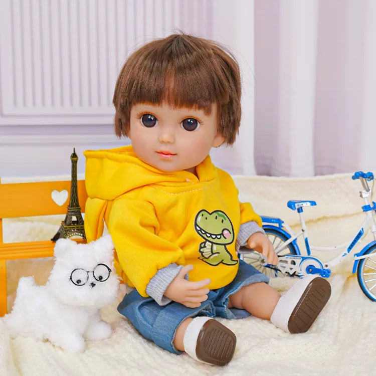 Casual doll with a dinosaur on its sweatshirt, beside a fluffy dog toy and a toy bike.