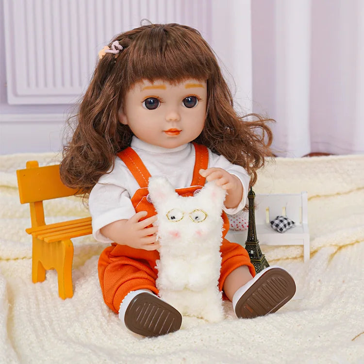 Doll in orange jumpsuit, sitting with a white plush dog and a toy camera.