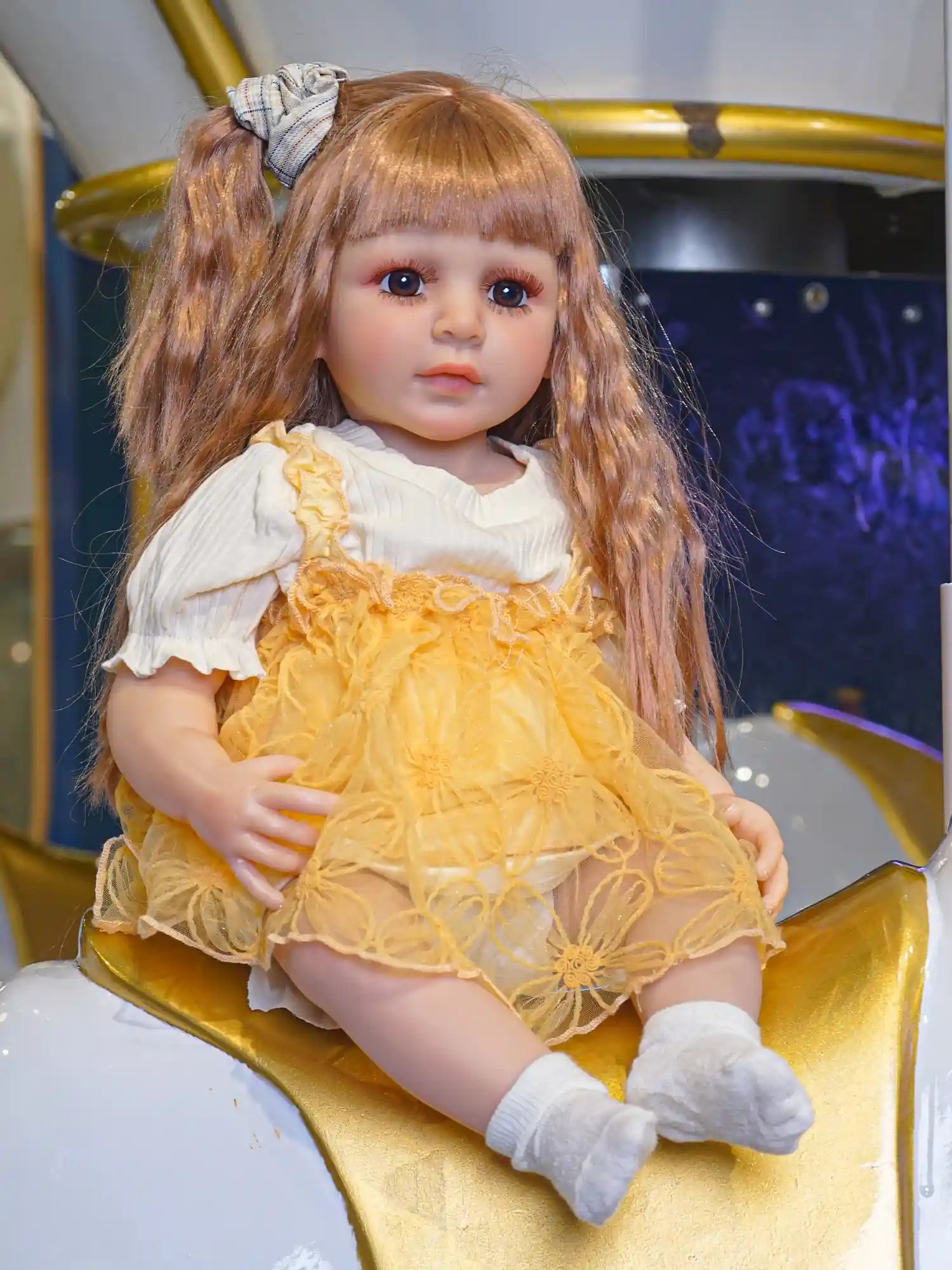 A doll that radiates playfulness, dressed in a joyful yellow outfit, with her hair sweetly tied up, ready for a day of fun.
