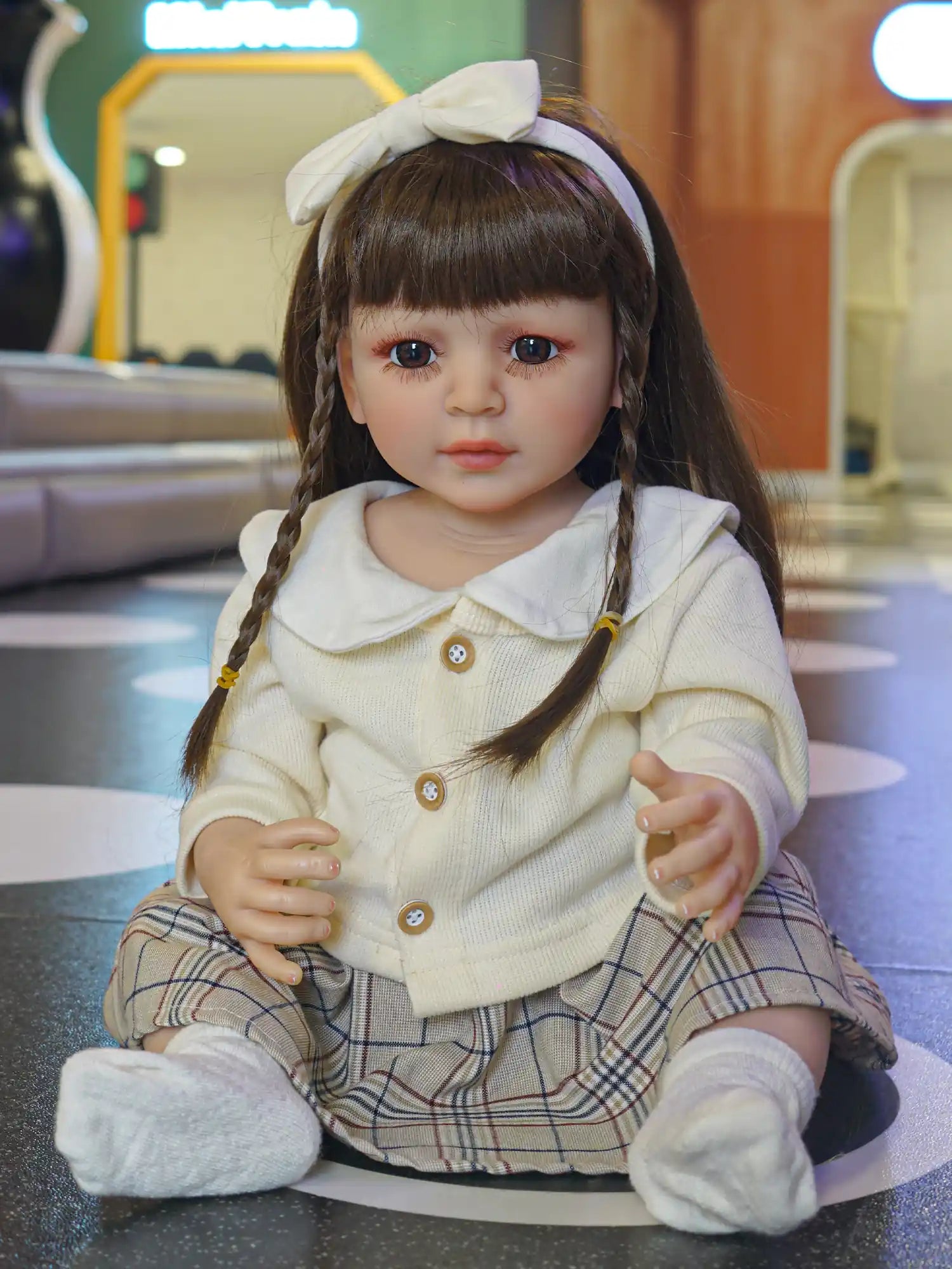 Charming doll capturing the essence of youth, with neatly styled braids and a preppy outfit, ready for storytelling.