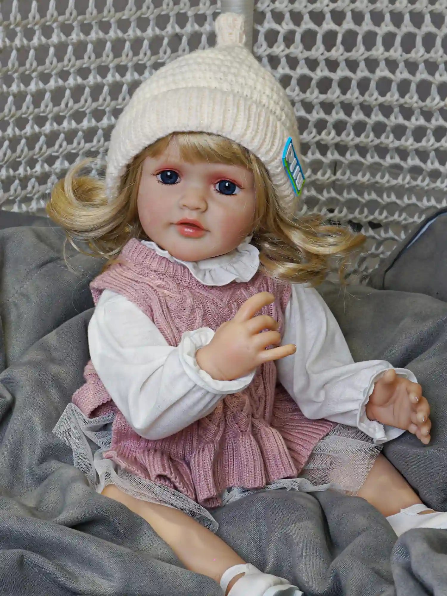 Experience the joy of parenthood with this exquisitely detailed reborn doll, featuring hand-painted features and silky golden locks.