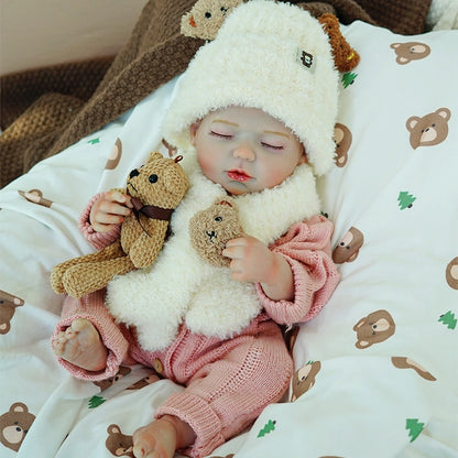 Reborn baby doll peacefully lying down, wearing a white sheep hat, holding a stuffed bear.