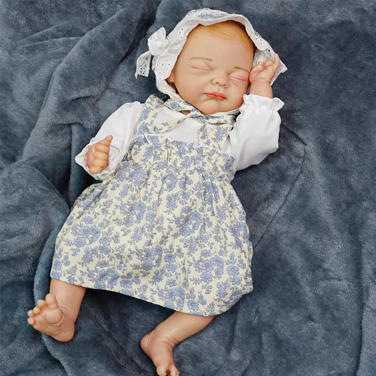 Another close-up of the first baby doll, where she appears to be in a deep sleep, her head adorned with the pink headband, and the colorful jumpsuit visible.