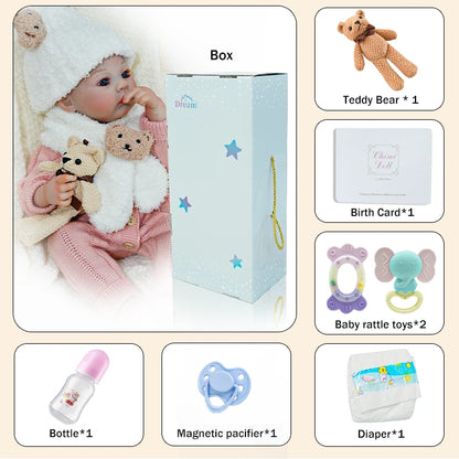 Complete set of accessories for the reborn baby doll, including a teddy bear, bottle, pacifier, and birth certificate.