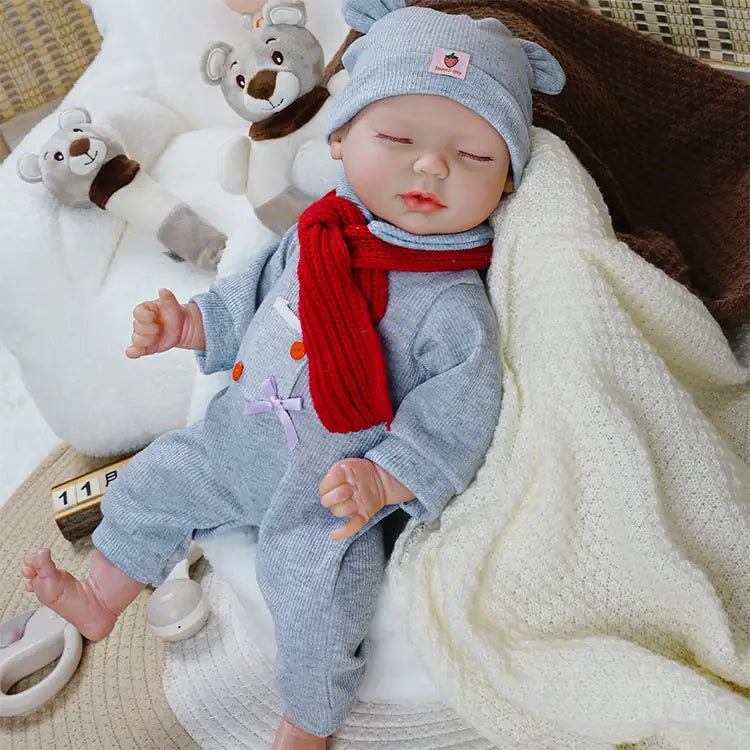 Handmade baby doll with winter accessories and pacifier.