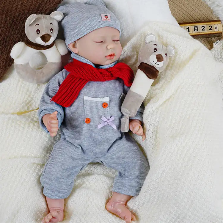Reborn baby doll in chic grey knit outfit and warm accessories.