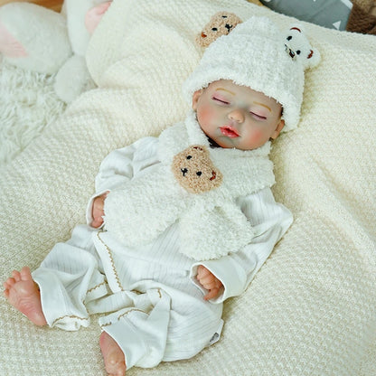 Reborn baby doll in packaging with accessories display.