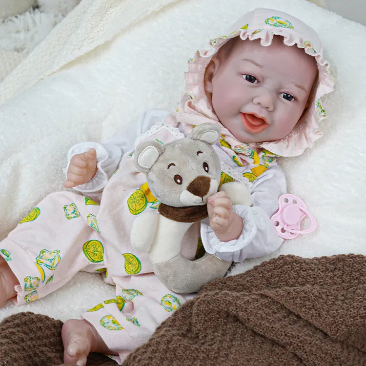A laughing reborn baby doll holding a teddy bear doll