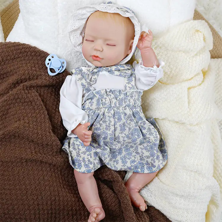 Realistic sleeping reborn doll in cozy nursery setting.