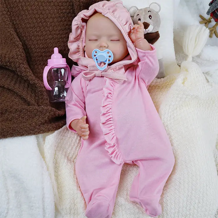 Newborn baby doll with pacifier in soft pink fleece.