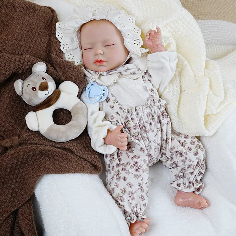 Handcrafted sleeping reborn baby girl with detailed features.