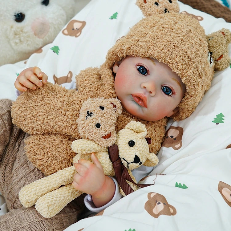 Close-up of reborn baby doll cuddling a teddy bear, resting peacefully.