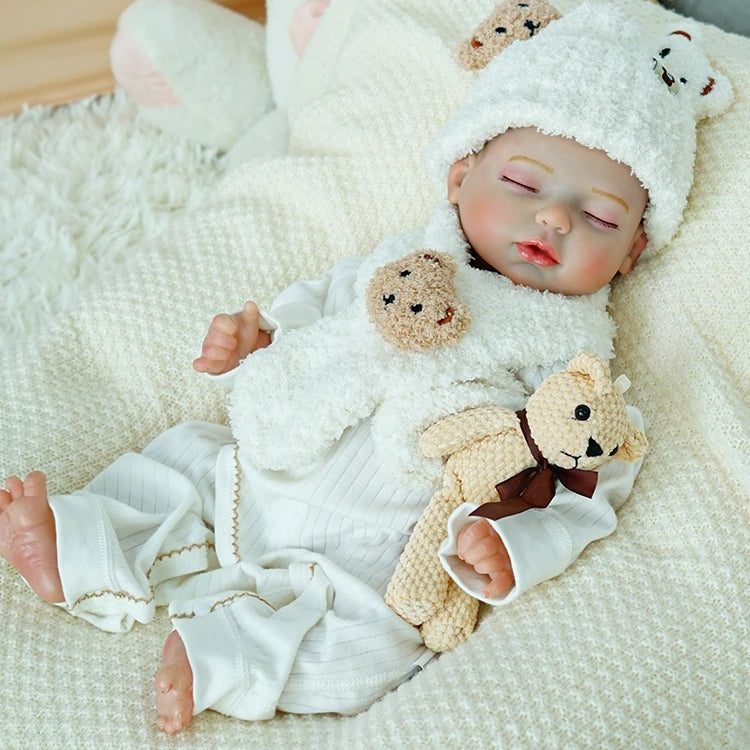 Close-up of reborn baby doll holding a teddy bear.