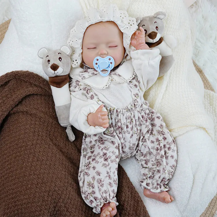 Heirloom quality sleeping newborn doll with soothing accessories.