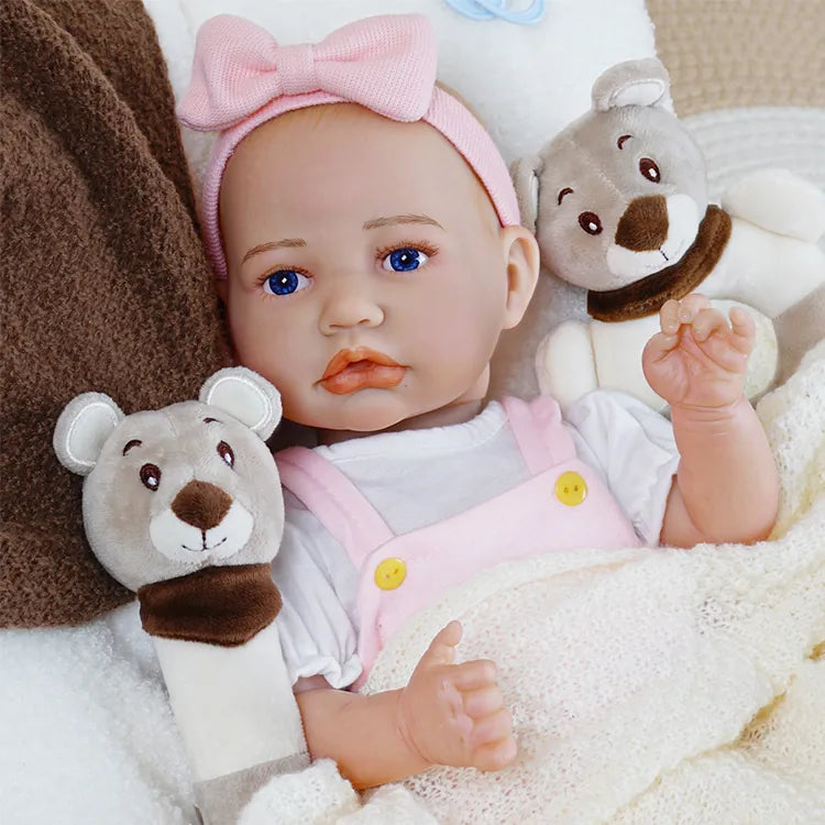 Pink-outfitted reborn baby doll with accessories