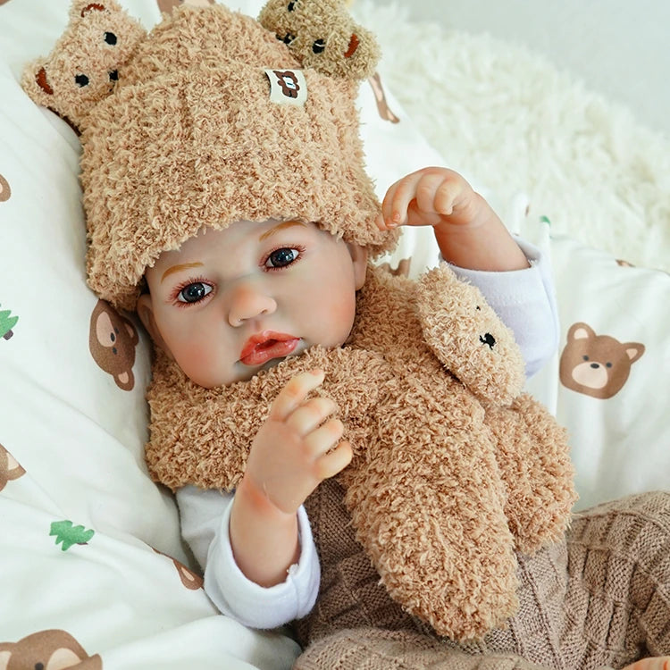 Close-up of the reborn baby doll, showing delicate facial features and lifelike expression.