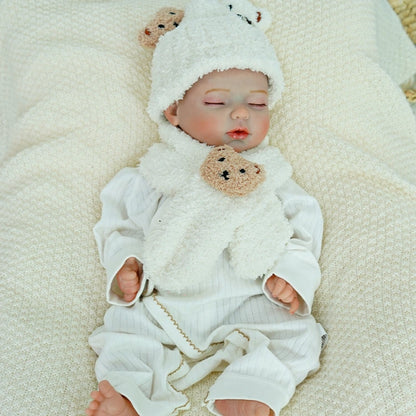 Side view of reborn baby doll sleeping with a cozy bear hat.