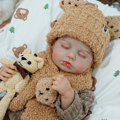 Reborn baby doll in a cozy bear-themed outfit with matching accessories.