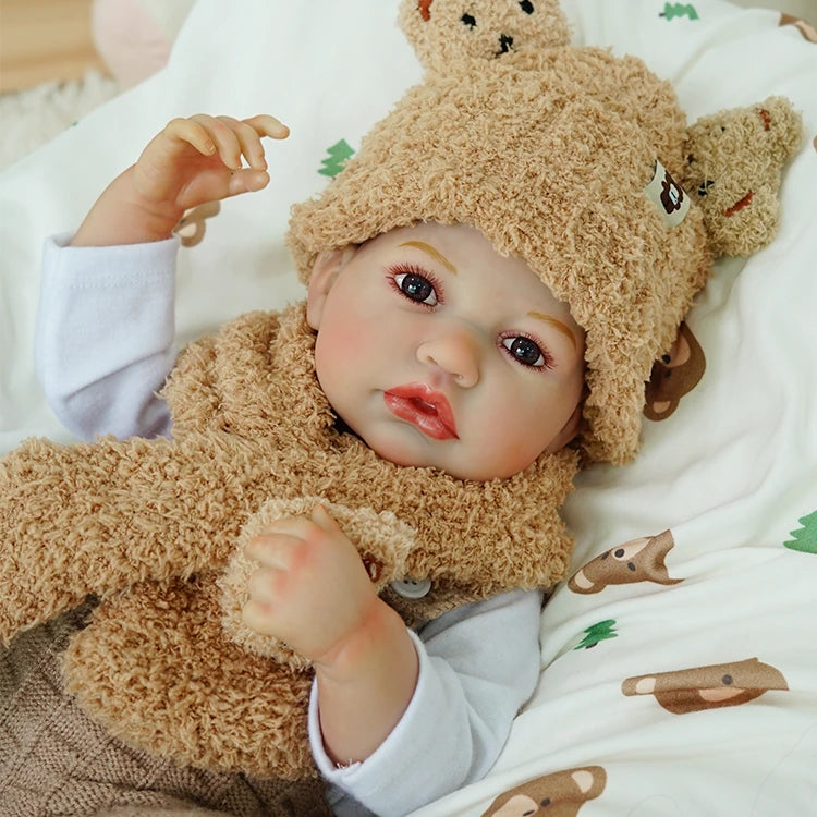 Reborn baby doll packaging display, including accessories: bottle, pacifier, toy, and birth certificate.