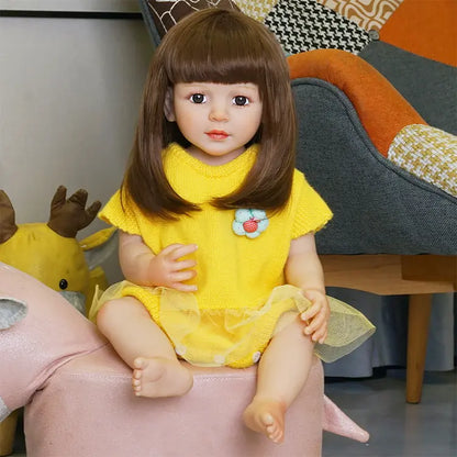 The doll sitting on the couch, facing forward, with a close-up of her face, highlighting her brown hair and large eyes.