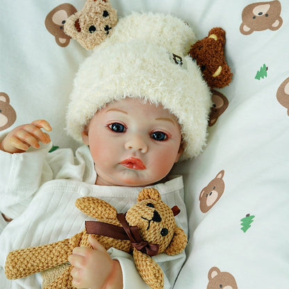 Close-up of the reborn doll hugging the teddy bear.