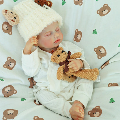 Reborn doll stretching with a teddy bear.