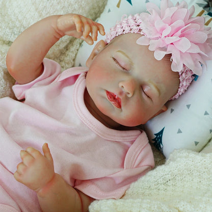 Detailed close-up of sleeping reborn baby doll.