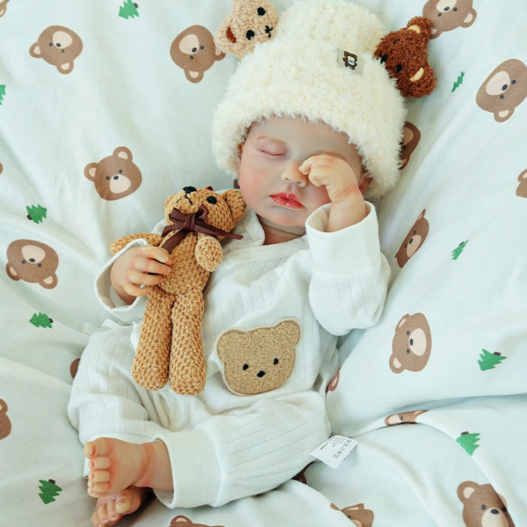 Doll sleeping, hand on the teddy bear.