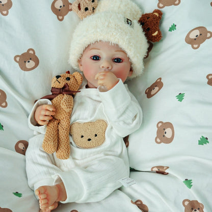 Reborn doll sitting with a teddy bear.