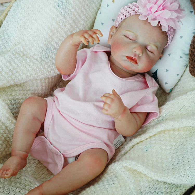 Sleeping reborn baby doll with a soft expression.