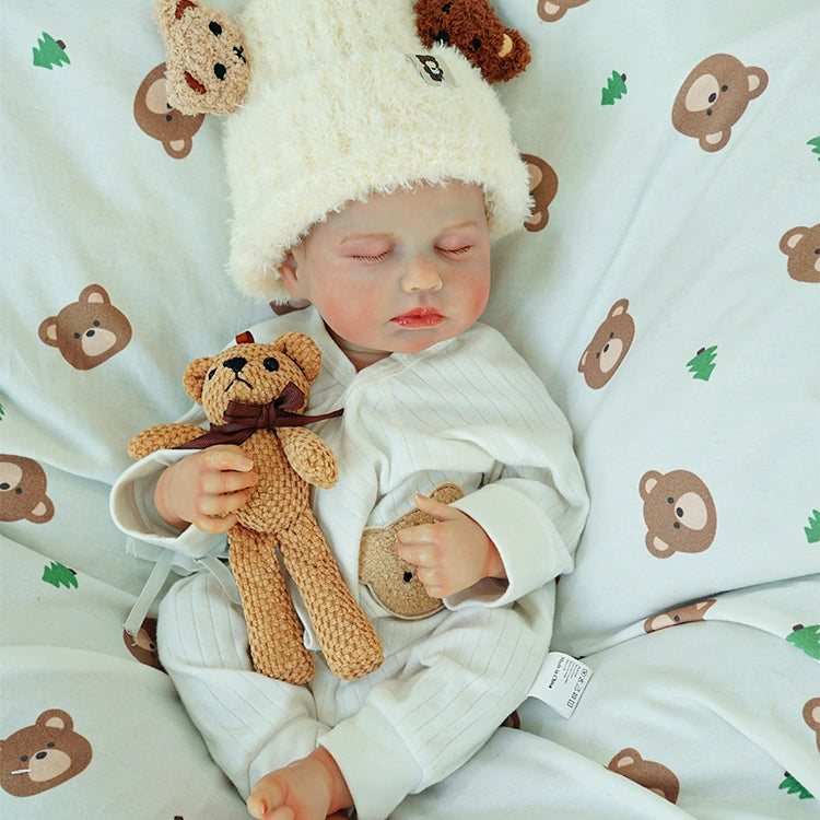 Doll resting with arms crossed, holding the teddy bear.