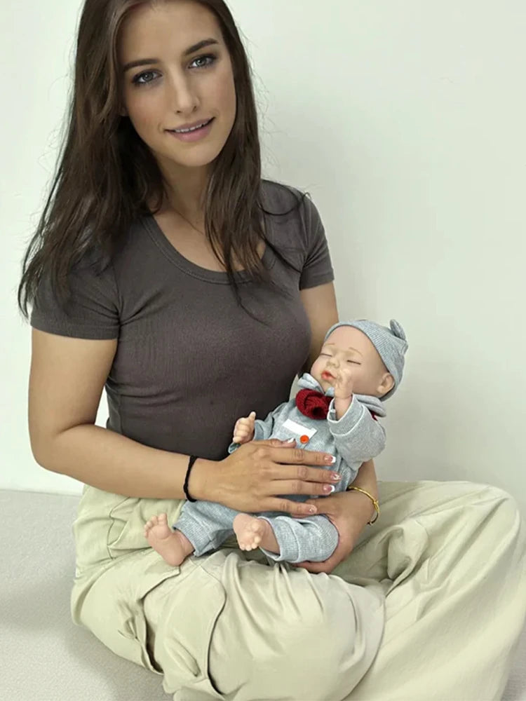 A woman holding a reborn baby doll in her arms