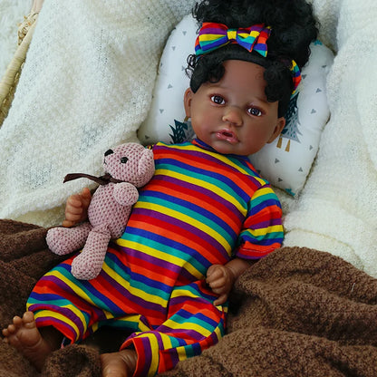 The third image shows the full body of the baby doll lying on the blanket, still holding the teddy bear, showcasing the outfit.